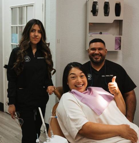 A satisfied patient with the Dr and Dental Assistant A satisfied patient with the Dr and Dental Assistant